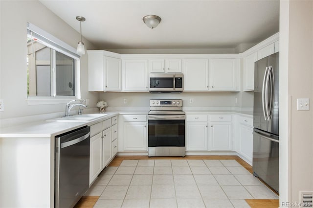 3098 W 107th Pl Unit C, Westminster, CO 80031 - kitchen featuring stainless steel appliances, a sink, white cabinets, and light countertops