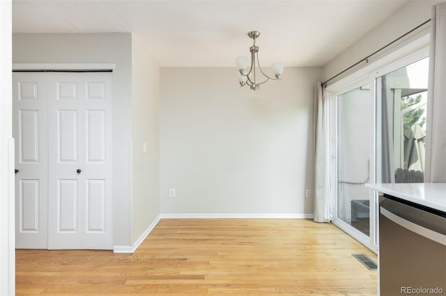 3098 W 107th Pl Unit C, Westminster, CO 80031 - unfurnished dining area with a chandelier, light wood finished floors, and baseboards