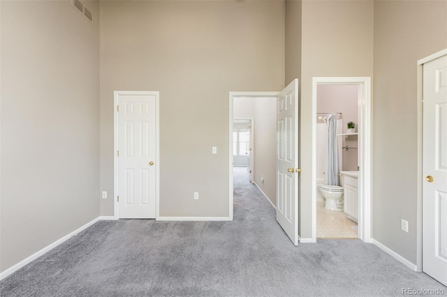 3098 W 107th Pl Unit C, Westminster, CO 80031 - unfurnished bedroom with a high ceiling, carpet flooring, baseboards, and ensuite bath
