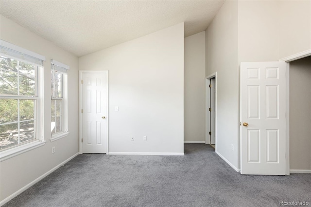 3098 W 107th Pl Unit C, Westminster, CO 80031 - carpeted empty room featuring vaulted ceiling, baseboards, and a textured ceiling