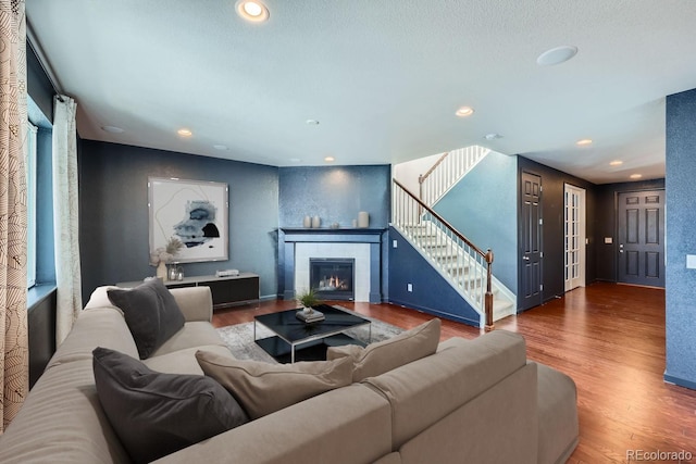 living room featuring a fireplace and hardwood / wood-style floors