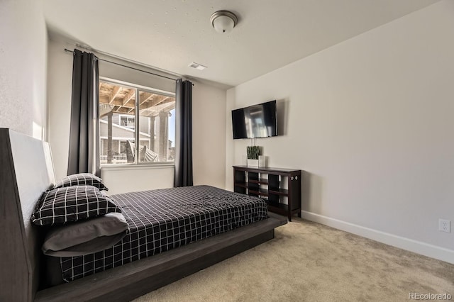 bedroom featuring light colored carpet