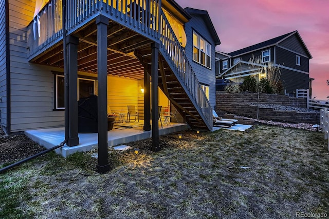 property exterior at dusk featuring a patio