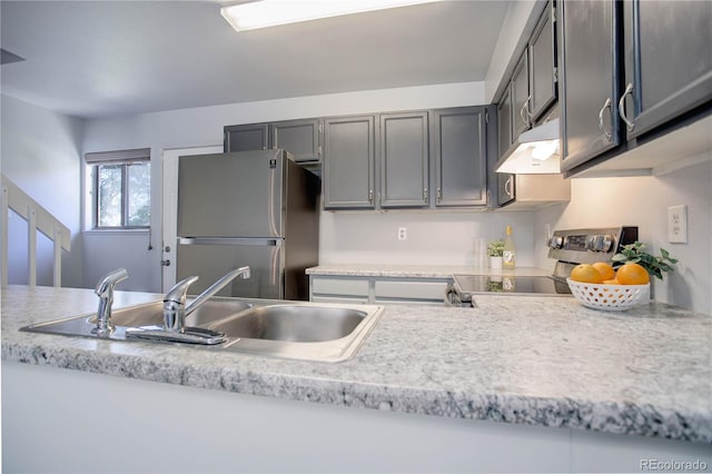 kitchen featuring appliances with stainless steel finishes, sink, and gray cabinetry