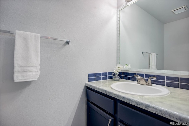 bathroom featuring decorative backsplash and vanity