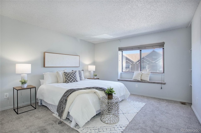 carpeted bedroom with a textured ceiling