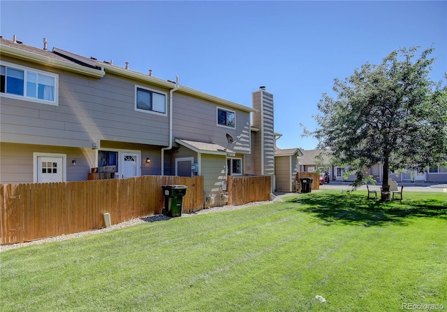 rear view of house with a yard