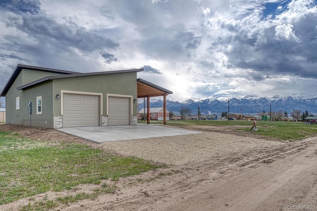806 S St, Silver Cliff, CO 81252 - garage with driveway and a mountain view