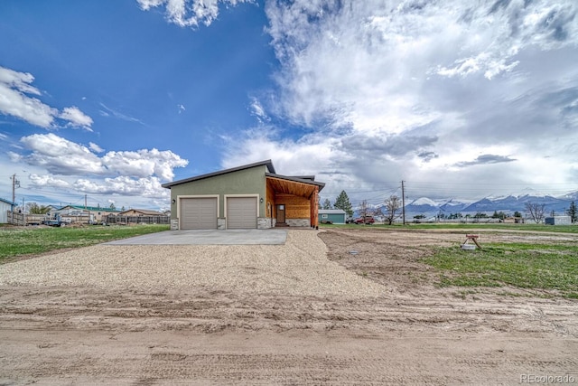 806 S St, Silver Cliff, CO 81252 - garage with concrete driveway and a mountain view