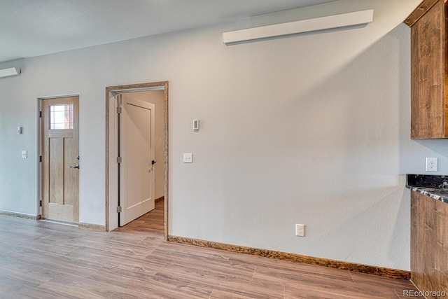 806 S St, Silver Cliff, CO 81252 - unfurnished dining area featuring light wood-style flooring and baseboards