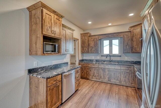 806 S St, Silver Cliff, CO 81252 - kitchen with appliances with stainless steel finishes, a sink, light wood-type flooring, dark stone counters, and recessed lighting