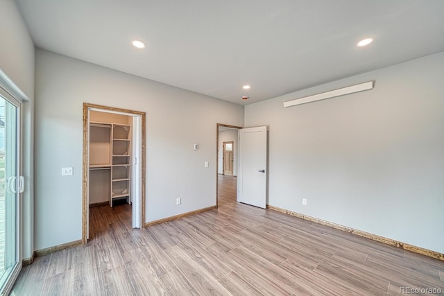 806 S St, Silver Cliff, CO 81252 - unfurnished bedroom featuring light wood-type flooring, a spacious closet, recessed lighting, baseboards, and a closet