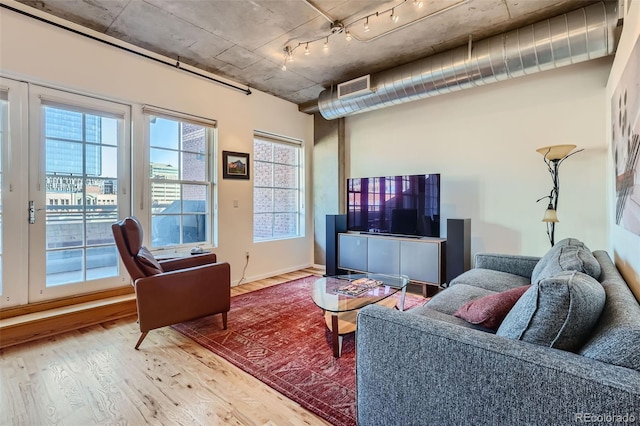1499 Blake St Unit 5I, Denver, CO 80202 - living room featuring wood finished floors and track lighting