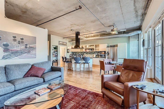 living room featuring ceiling fan and hardwood / wood-style floors