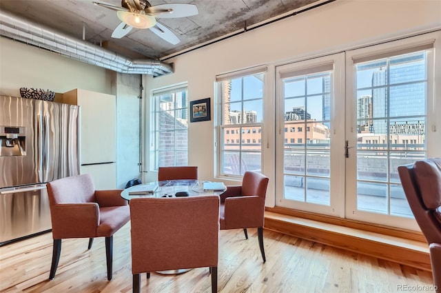 1499 Blake St Unit 5I, Denver, CO 80202 - dining space with light wood-type flooring, a ceiling fan, and a desk
