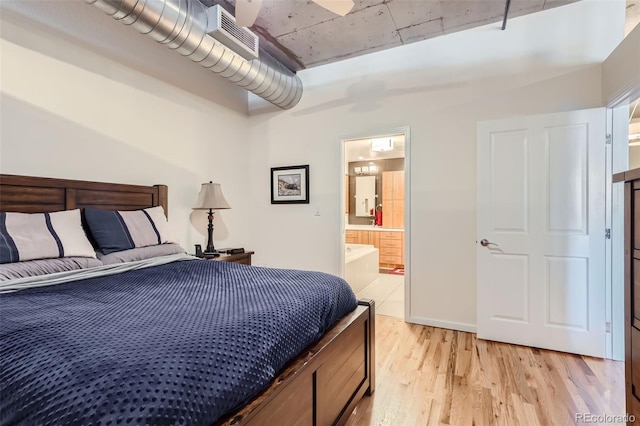 bedroom featuring ceiling fan, connected bathroom, and light hardwood / wood-style floors