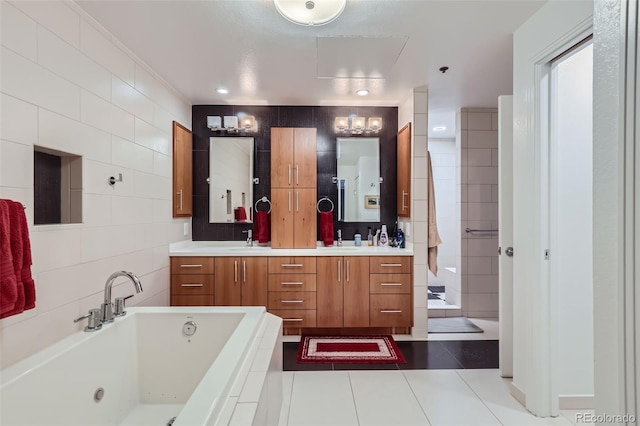 bathroom with tile patterned flooring, a bath, vanity, and tile walls