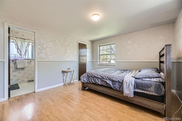 661 S Paris St, Aurora, CO 80012 - bedroom featuring wood finished floors and ensuite bathroom