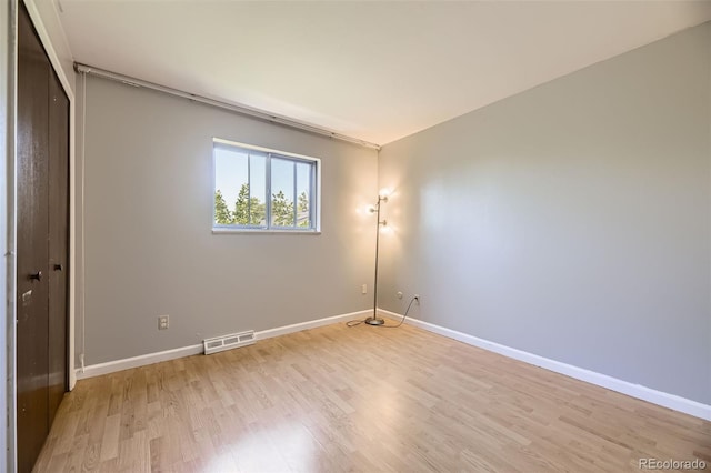 661 S Paris St, Aurora, CO 80012 - unfurnished bedroom featuring light wood finished floors and baseboards