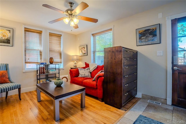 433 Fox St, Denver, CO 80204 - living area with a ceiling fan, plenty of natural light, baseboards, and light wood-style floors