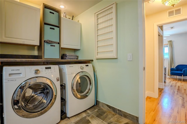 433 Fox St, Denver, CO 80204 - laundry room with cabinet space, washing machine and dryer, baseboards, and wood finished floors