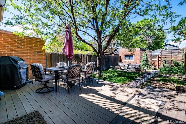 433 Fox St, Denver, CO 80204 - deck with outdoor dining area, a fenced backyard, and grilling area