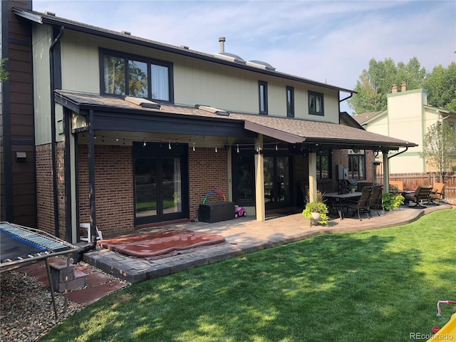 7844 W Friend Dr, Littleton, CO 80128 - rear view of property with french doors, brick siding, a patio, and a chimney