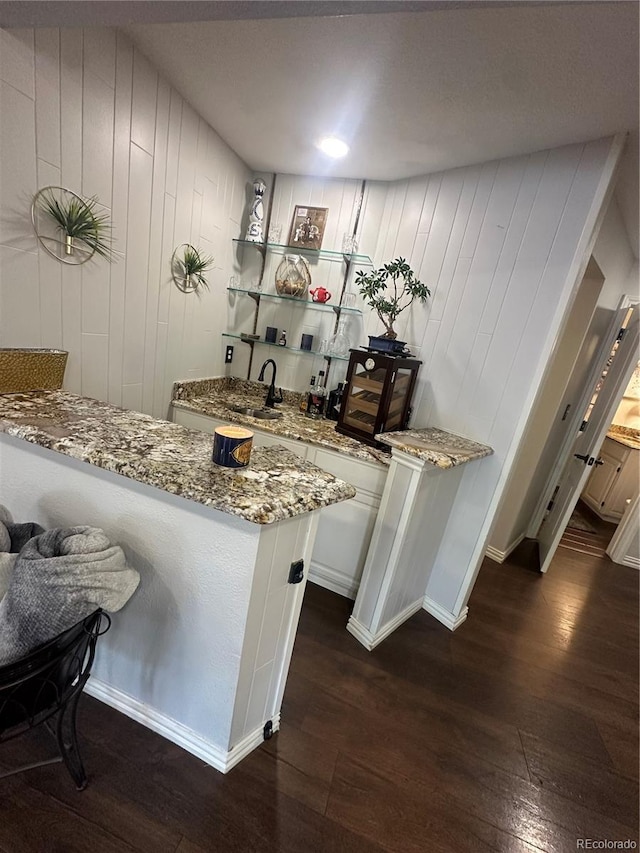 7844 W Friend Dr, Littleton, CO 80128 - indoor wet bar featuring dark wood-type flooring and baseboards