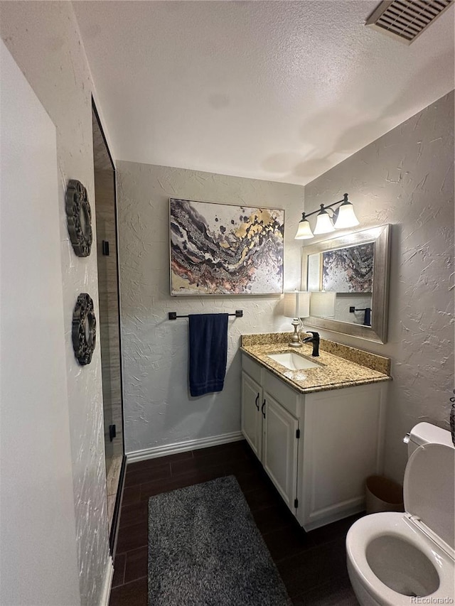 7844 W Friend Dr, Littleton, CO 80128 - bathroom with a textured wall, a textured ceiling, a stall shower, and vanity