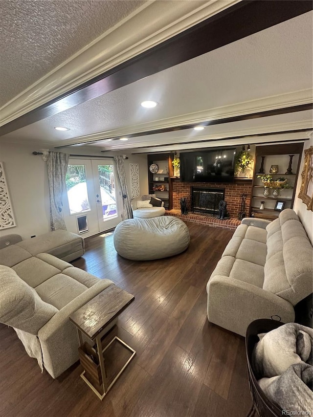 7844 W Friend Dr, Littleton, CO 80128 - living room featuring wood-type flooring, a textured ceiling, a brick fireplace, french doors, and recessed lighting