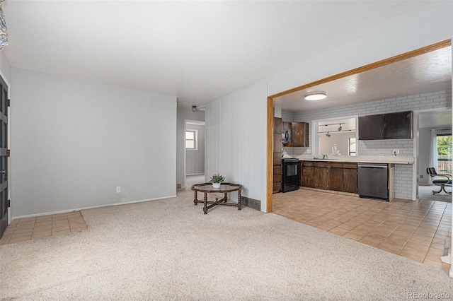 7644 Wyandot St, Denver, CO 80221 - living room featuring light colored carpet and light tile patterned floors