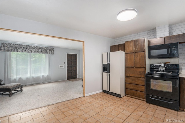 7644 Wyandot St, Denver, CO 80221 - kitchen with black appliances, light carpet, and open floor plan