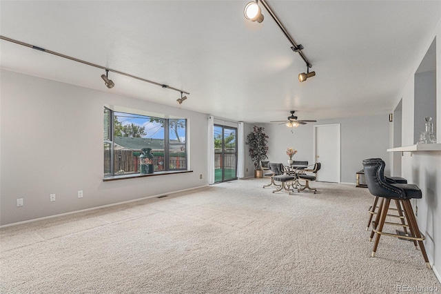 7644 Wyandot St, Denver, CO 80221 - carpeted living room featuring rail lighting and a ceiling fan