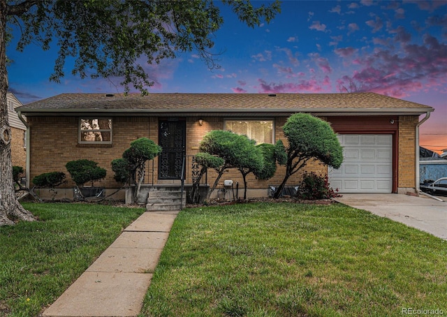 7644 Wyandot St, Denver, CO 80221 - ranch-style house with a garage, a yard, driveway, and brick siding