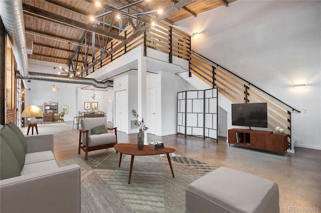 3033 Blake St Unit 121, Denver, CO 80205 - living area with stairway, a chandelier, a towering ceiling, and wood ceiling