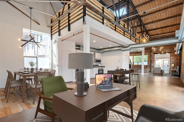 3033 Blake St Unit 121, Denver, CO 80205 - living room with a towering ceiling, a chandelier, and brick wall