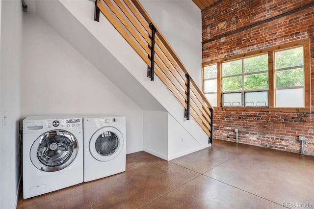 3033 Blake St Unit 121, Denver, CO 80205 - washroom featuring brick wall and washing machine and clothes dryer