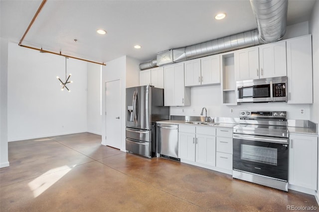 3033 Blake St Unit 121, Denver, CO 80205 - kitchen with stainless steel appliances, concrete flooring, recessed lighting, light countertops, and white cabinetry