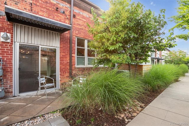 3033 Blake St Unit 121, Denver, CO 80205 - view of exterior entry featuring brick siding