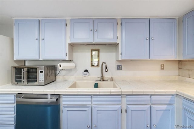 7172 S Vine Cir, Centennial, CO 80122 - kitchen featuring appliances with stainless steel finishes, a sink, and tile countertops