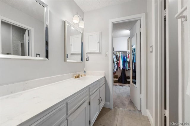 7172 S Vine Cir, Centennial, CO 80122 - bathroom with a textured ceiling, tile patterned floors, and vanity