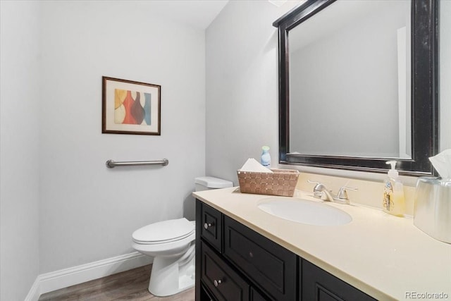 7172 S Vine Cir, Centennial, CO 80122 - half bath with wood finished floors, vanity, toilet, and baseboards