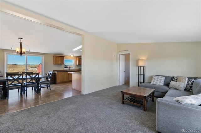 living room with a chandelier, dark carpet, and sink