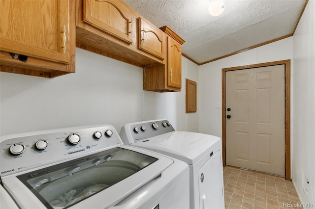 laundry room with cabinets, ornamental molding, a textured ceiling, and washing machine and clothes dryer