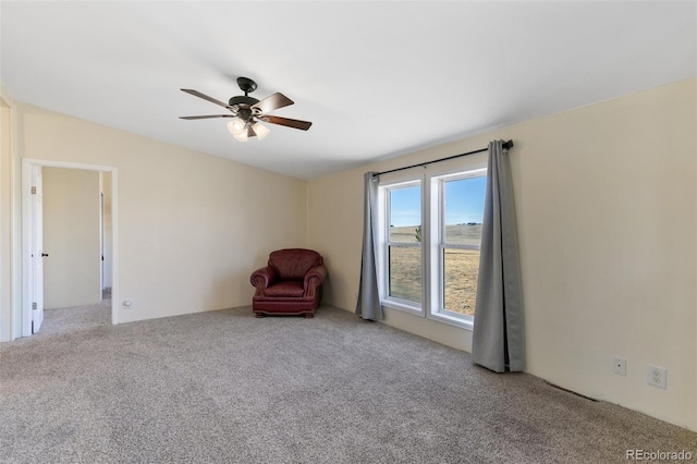 unfurnished room featuring light colored carpet and ceiling fan