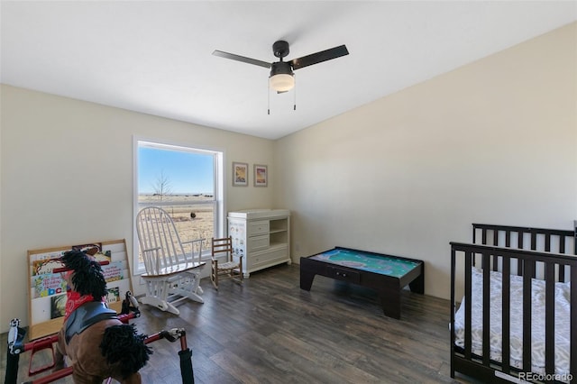 bedroom with dark hardwood / wood-style flooring and ceiling fan