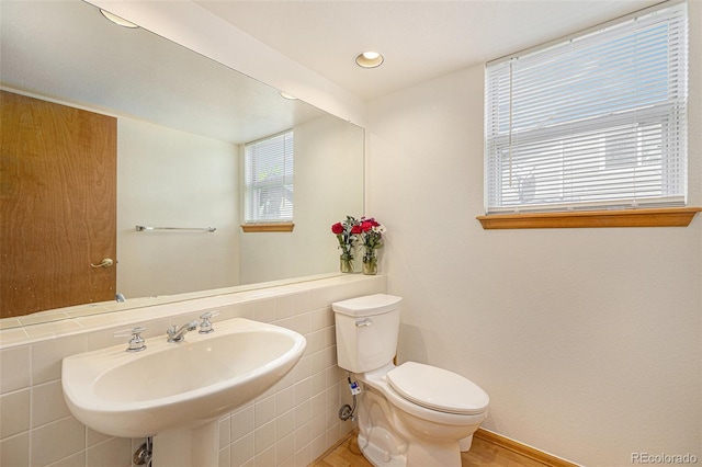 9346 Lark Sparrow Dr, Highlands Ranch, CO 80126 - half bathroom with toilet, wood finished floors, a sink, and recessed lighting