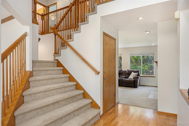 9346 Lark Sparrow Dr, Highlands Ranch, CO 80126 - staircase with wood finished floors, recessed lighting, baseboards, and carpet