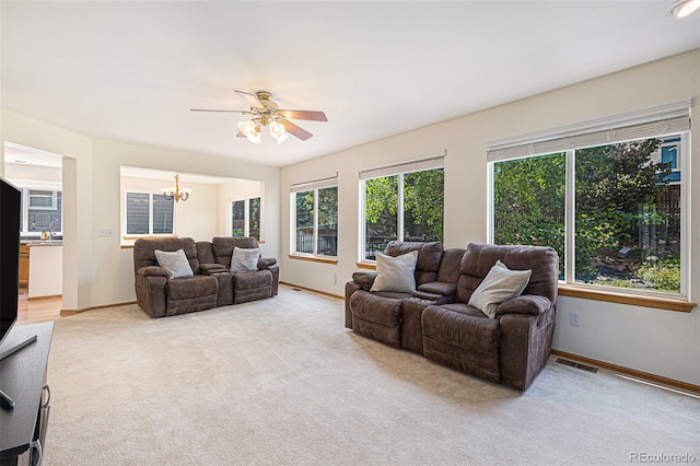 9346 Lark Sparrow Dr, Highlands Ranch, CO 80126 - living area with light colored carpet, a chandelier, and baseboards