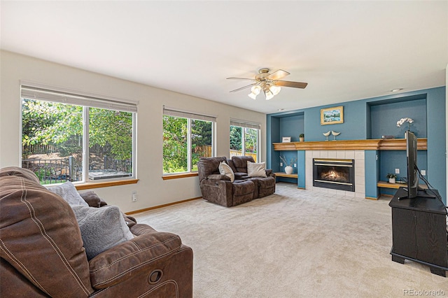 9346 Lark Sparrow Dr, Highlands Ranch, CO 80126 - carpeted living area with ceiling fan, a tile fireplace, baseboards, and built in features